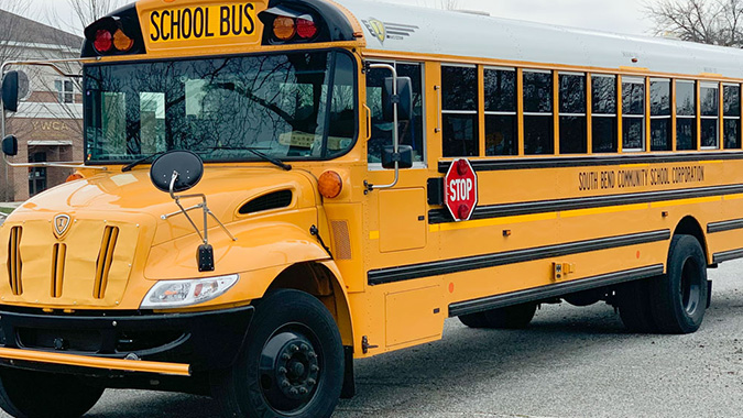 School bus parked in front of school.