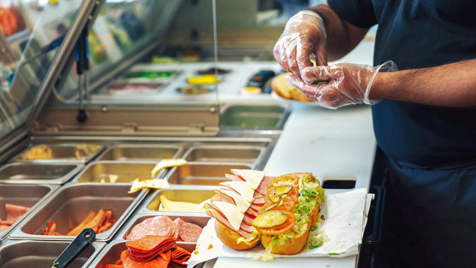 A Subway sandwich being made.